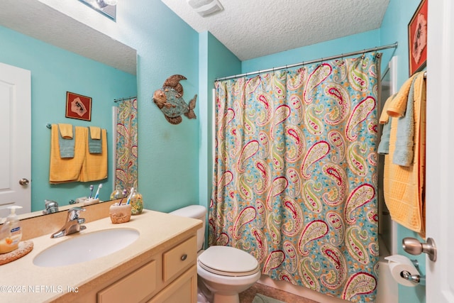 bathroom with toilet, vanity, and a textured ceiling