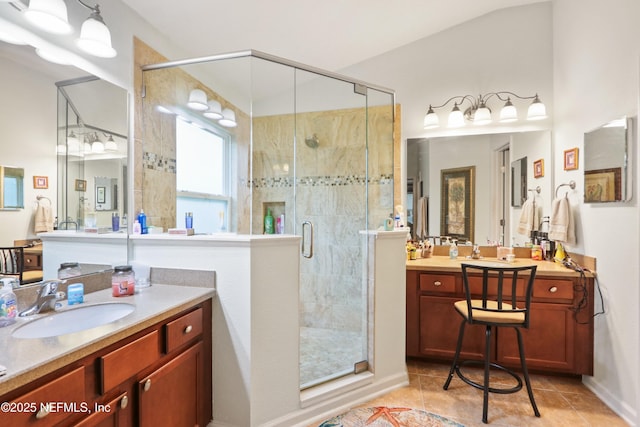 bathroom with vanity, a shower with shower door, and tile patterned floors