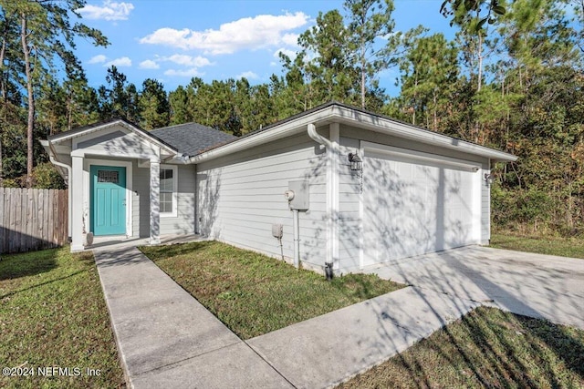 ranch-style home featuring a front yard and a garage