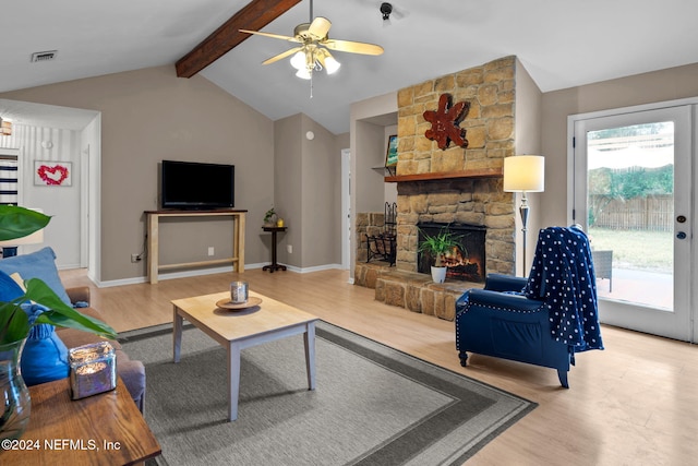 living room with a fireplace, vaulted ceiling with beams, light wood-type flooring, and ceiling fan