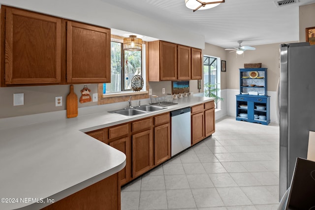 kitchen with stainless steel appliances, ceiling fan, and sink