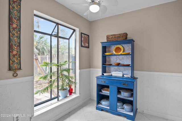 doorway to outside featuring ceiling fan and light tile patterned flooring