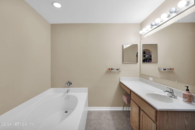 bathroom featuring tile patterned flooring, vanity, and a bathing tub