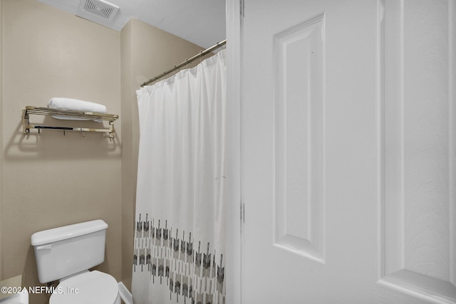 bathroom with toilet and radiator