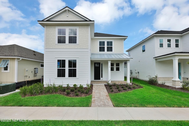 118 Caiden Dr, Ponte Vedra, FL 32081 - view of front facade with covered porch, a front lawn, and metal roof