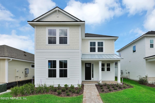 118 Caiden Dr, Ponte Vedra, FL 32081 - view of front of property with covered porch, a front yard, metal roof, and a standing seam roof