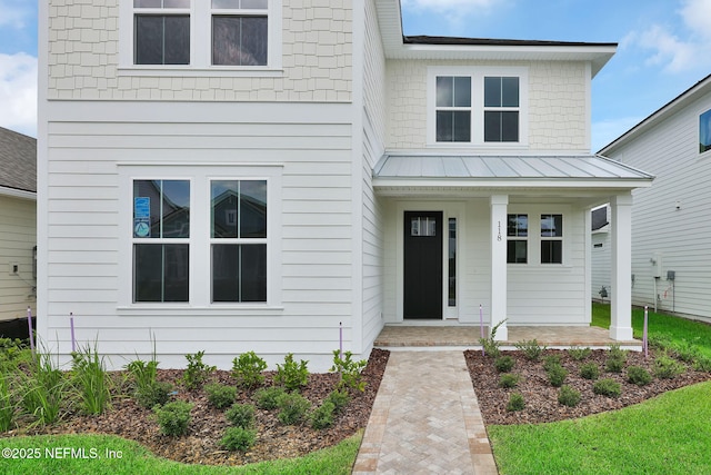 118 Caiden Dr, Ponte Vedra, FL 32081 - view of front facade featuring covered porch, metal roof, and a standing seam roof