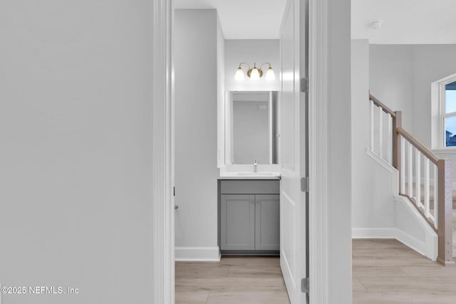 118 Caiden Dr, Ponte Vedra, FL 32081 - hall featuring light wood-type flooring, stairs, a sink, and baseboards