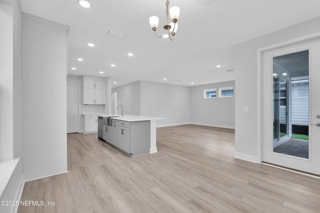 118 Caiden Dr, Ponte Vedra, FL 32081 - kitchen with light countertops, light wood-type flooring, recessed lighting, a chandelier, and white cabinetry