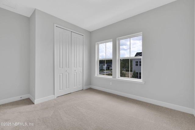 118 Caiden Dr, Ponte Vedra, FL 32081 - unfurnished bedroom featuring light carpet, baseboards, and a closet