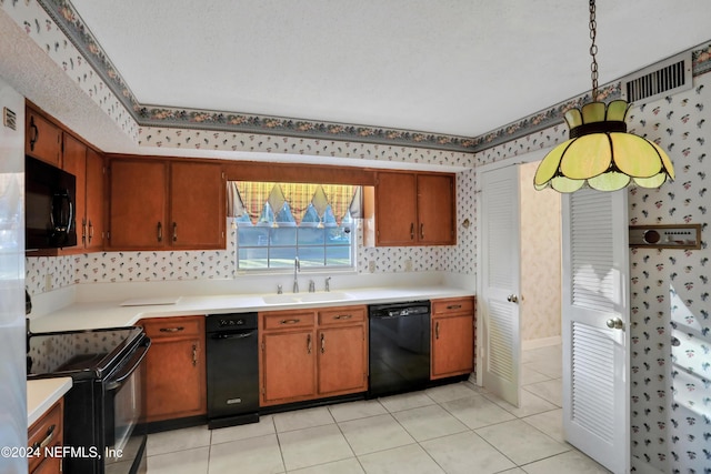 kitchen featuring black appliances, light tile patterned floors, sink, and a textured ceiling