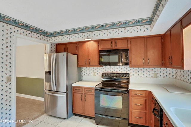 kitchen featuring black appliances and light tile patterned flooring