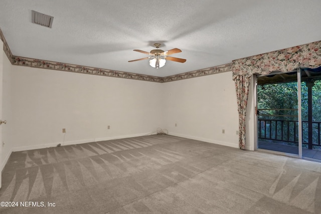 unfurnished room featuring ceiling fan, carpet, and a textured ceiling