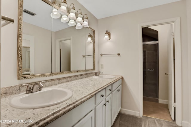 bathroom with tile patterned floors, vanity, and a shower with shower door