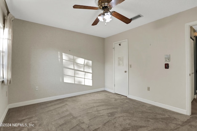 carpeted empty room with ceiling fan