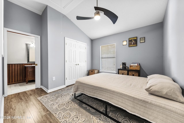 bedroom featuring lofted ceiling, ceiling fan, hardwood / wood-style floors, connected bathroom, and a closet