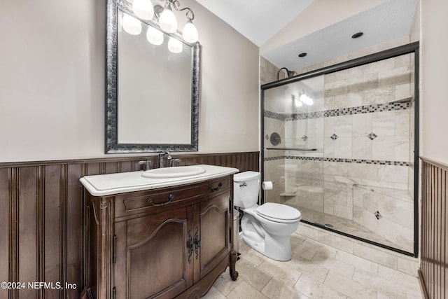 bathroom featuring lofted ceiling, toilet, a shower with door, and vanity