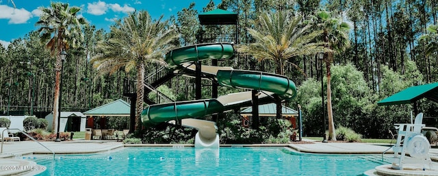 view of swimming pool with a gazebo, a water slide, and a patio area