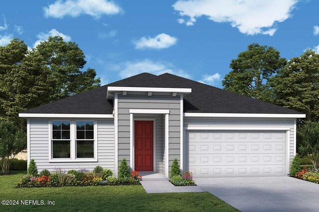 view of front of home with a front yard and a garage