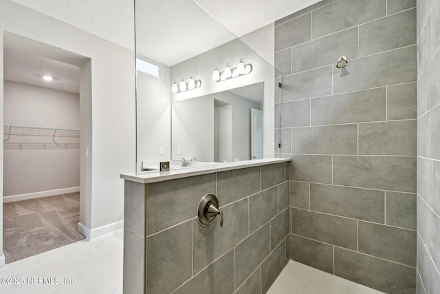 75484 Banyan Way, Yulee, FL 32097 - bathroom with walk in shower, a spacious closet, and baseboards