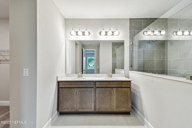 75484 Banyan Way, Yulee, FL 32097 - full bathroom featuring walk in shower, baseboards, double vanity, and a spacious closet