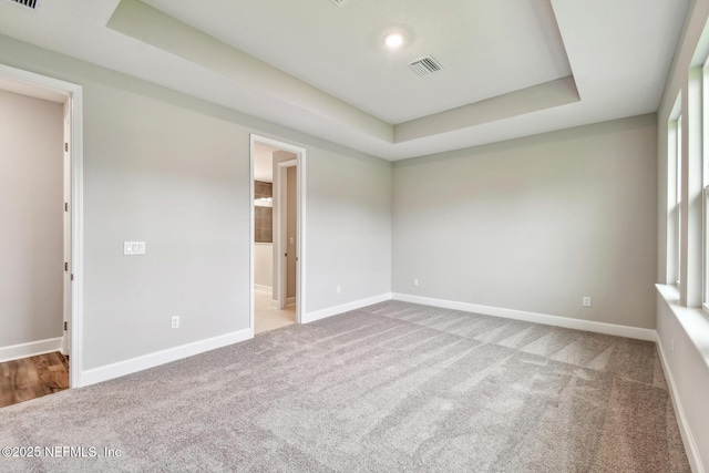 75484 Banyan Way, Yulee, FL 32097 - empty room featuring a tray ceiling, carpet, baseboards, and recessed lighting