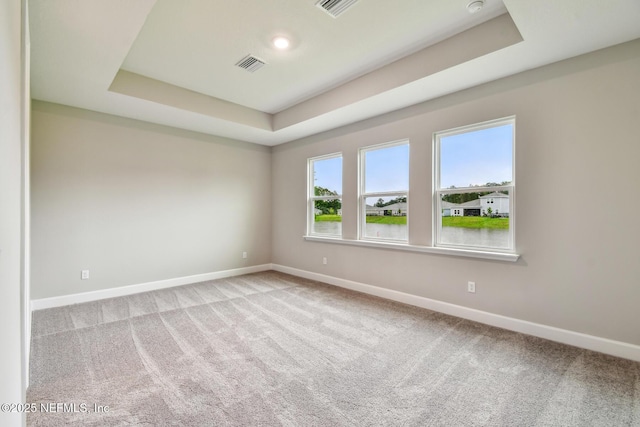 75484 Banyan Way, Yulee, FL 32097 - spare room with a tray ceiling, baseboards, and carpet