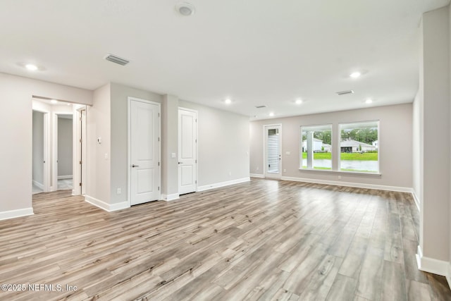 75484 Banyan Way, Yulee, FL 32097 - unfurnished living room featuring light wood-type flooring, baseboards, and recessed lighting