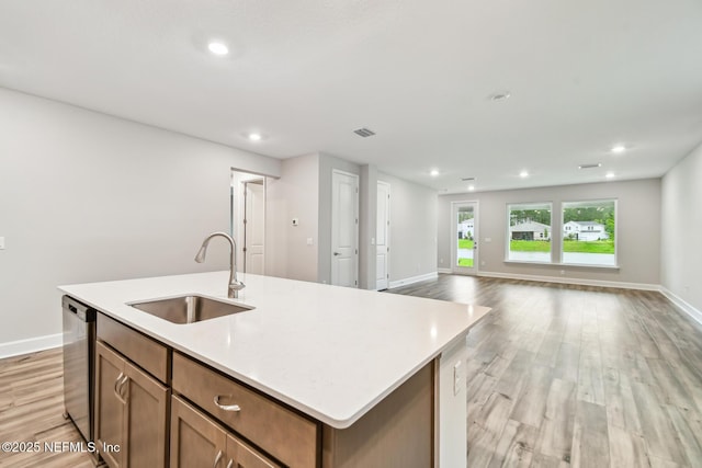 75484 Banyan Way, Yulee, FL 32097 - kitchen featuring a sink, dishwasher, light wood-style floors, light countertops, and recessed lighting