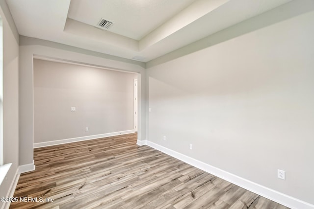 75484 Banyan Way, Yulee, FL 32097 - spare room featuring wood finished floors, baseboards, and a raised ceiling