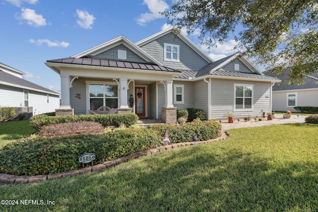 craftsman-style home with covered porch and a front yard