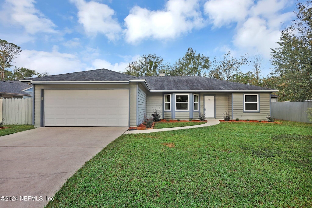 ranch-style home with a front yard and a garage