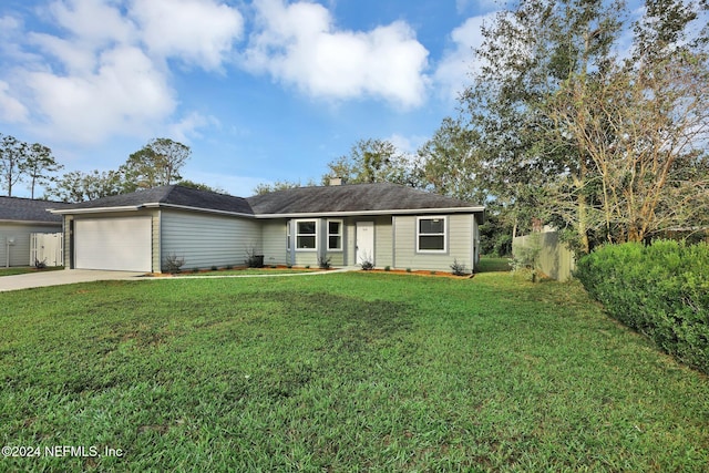 ranch-style house featuring a garage and a front yard