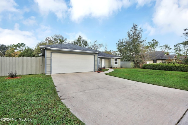 ranch-style house with a garage and a front lawn