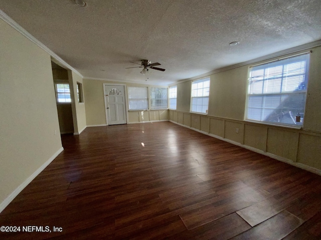 unfurnished room featuring a textured ceiling, ceiling fan, ornamental molding, and dark wood-type flooring