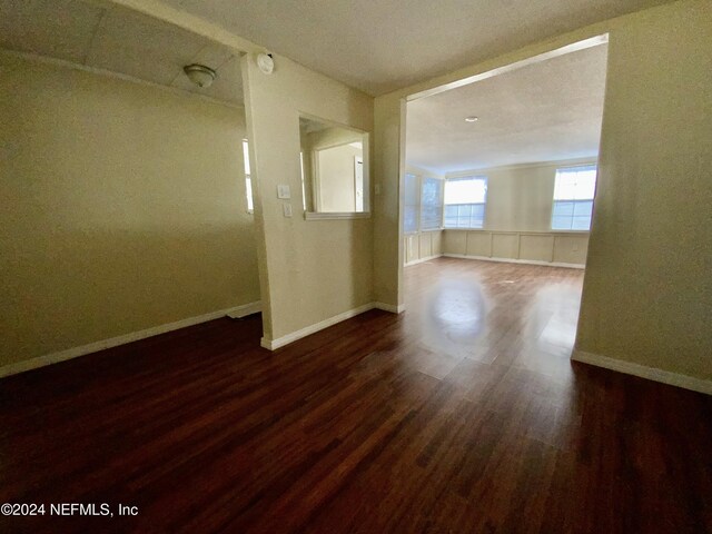 spare room with dark hardwood / wood-style floors