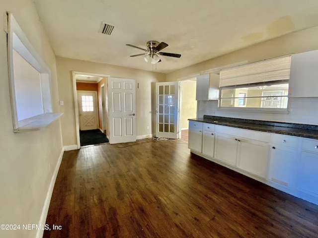 kitchen featuring dark hardwood / wood-style flooring, ceiling fan, plenty of natural light, and white cabinets