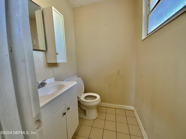 bathroom featuring tile patterned flooring, vanity, and toilet