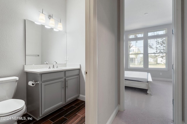 bathroom featuring hardwood / wood-style floors, vanity, and toilet