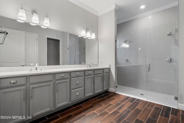 bathroom with crown molding, vanity, and walk in shower