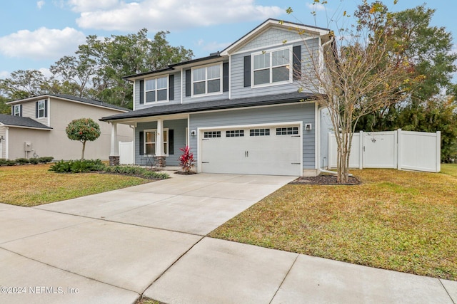 view of front of house with a front lawn, covered porch, and a garage