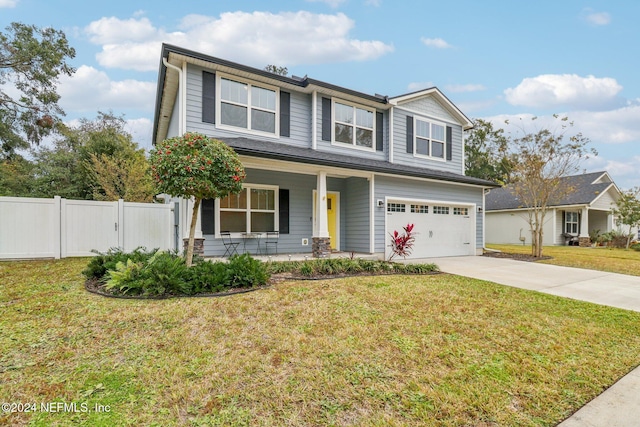 view of front of property with covered porch, a front yard, and a garage