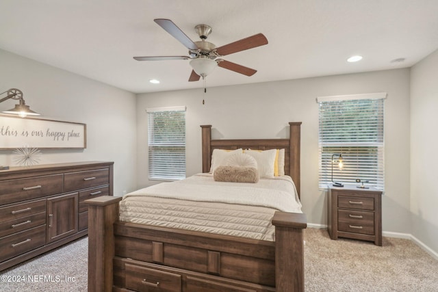 bedroom with light colored carpet and ceiling fan