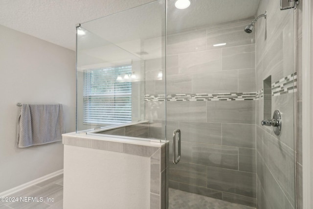 bathroom with a shower with shower door