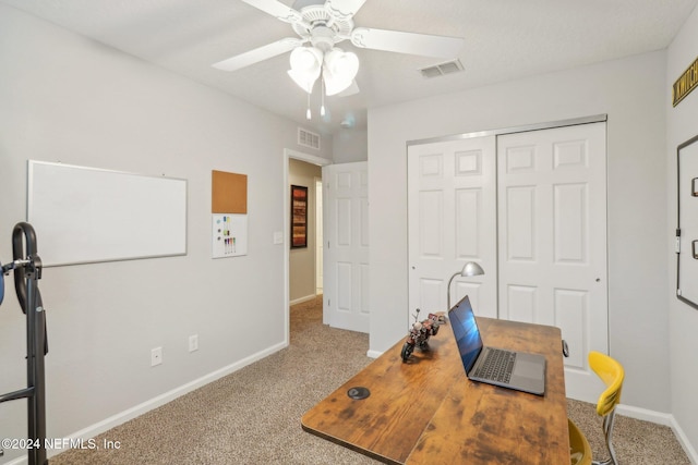 carpeted office with ceiling fan