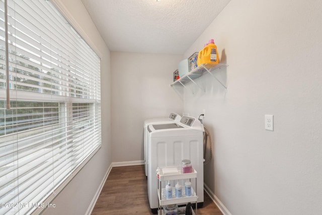 laundry room with a textured ceiling, dark hardwood / wood-style flooring, and washing machine and clothes dryer