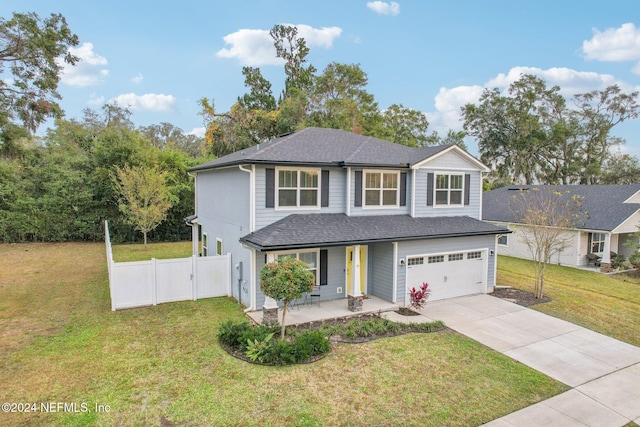 view of front of property with a front yard, a porch, and a garage