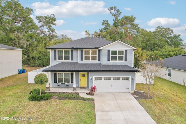 view of front facade with a porch, a garage, and a front lawn