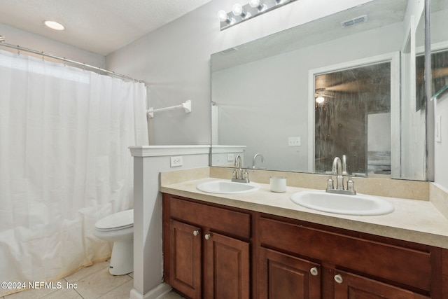 bathroom with tile patterned floors, a textured ceiling, vanity, ceiling fan, and toilet