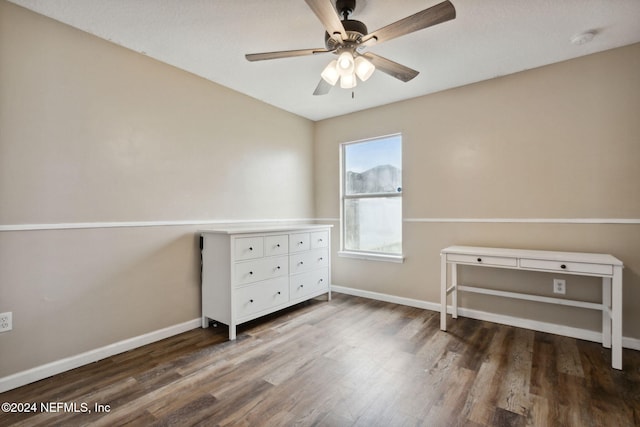 unfurnished bedroom with ceiling fan and dark hardwood / wood-style flooring